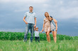 © beatleoff - Happy family of four walking through the field. Mother father son daughter Smiling and laughing. Girl with parents and her little  brother