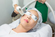 © jayzynism - Close-up of Beautician Giving Laser Epilation Treatment To Young Woman Face.
