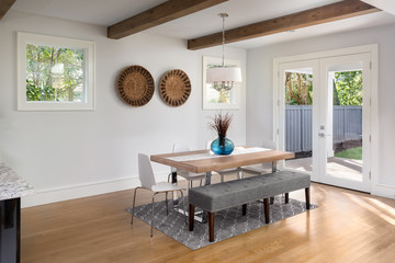 Elegant Dining Room in New Luxury Home with French Doors Leading to Patio and Landscaped Backyard