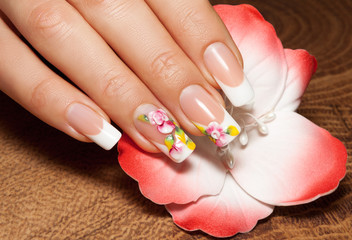 Wall Mural - Nail extensions. Manicure and flower painting. Isolated.