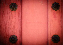Red Wooden Door With Four Rusty Flower Bolt. Vintage Background. Vignette.
