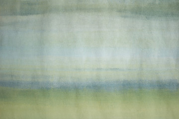 Close-up photo of a hand painted, light blue and green abstract painting. Simple image of an empty, minimalist, monochromatic background.