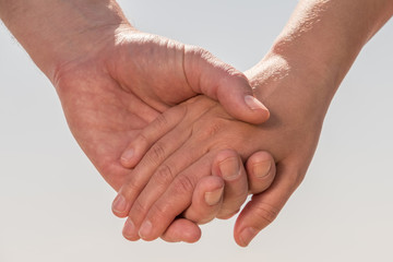 Couple holds hands