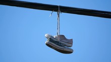 High Quality Video Of Pair Of Shoes Hang Tossed Telephone Wire In 4K