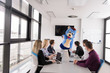 © .shock - boss dresed as bear having fun with business people in trendy office