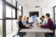 © .shock - boss dresed as bear having fun with business people in trendy office