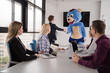 © .shock - boss dresed as bear having fun with business people in trendy office