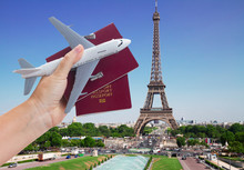 Plane Travel Concept, Hand Holding Passports With Plane, Paris France Cityscape In Background