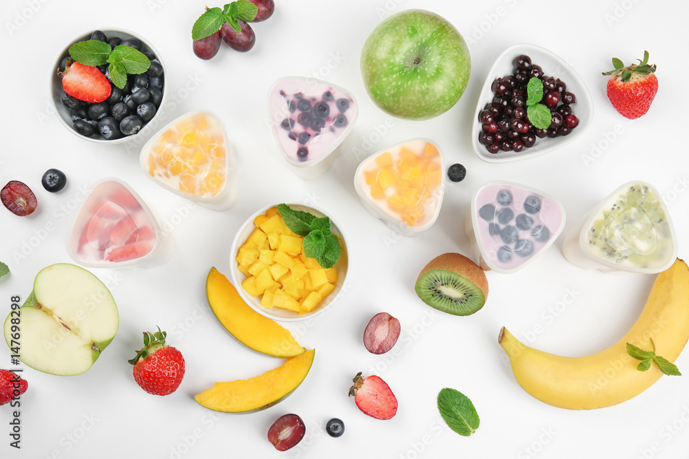 Bowls from automatic yogurt maker with fruits on white background