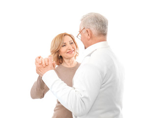 Happy senior couple dancing on white background