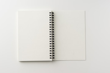 Wall Mural - Business concept - Top view of spiral blank notebook on white background desk for mockup