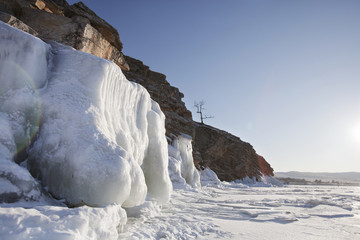 Icicles. Coast rock of Lake Baikal. Winter landscape