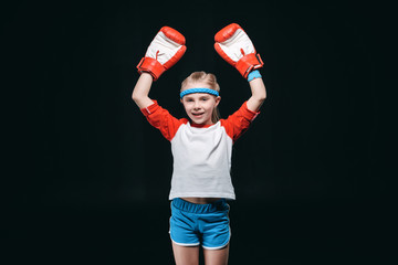 Wall Mural - sportive girl in boxing gloves isolated on black, active kids concept