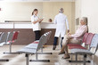 Doctors and patient discussing in hospital waiting room