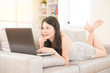 © PR Image Factory - beautiful woman working on laptop on couch