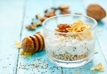 Wall Mural - Healthy dietary breakfast - chia pudding with muesli, cereal flakes, walnut and honey in a glass bowl