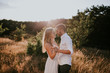 © Alina Schessler - Young couple  standing in meadow