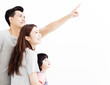 © Tom Wang - Happy Young Family pointing and looking up.