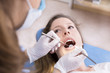 © s4svisuals - Dentist examining a patient's teeth to the dentist