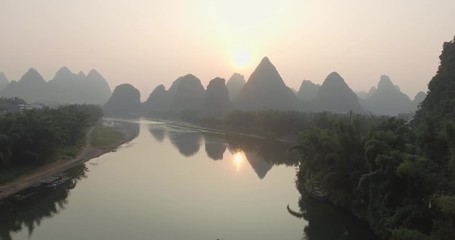 Wall Mural - Aerial view of sunrise over landscape of Yangshuo, Guanxi province, Guilin City, China. Li River and karst mountains top view. Travel, adventure and picturesque famous destination concept.