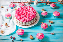Cake And Cupcakes With Pink Cream On Blue Wood Background. Pink Cakes.