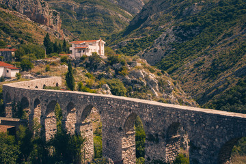 Wall Mural - View of ancient aqueduct, stone bridge in Old Bar (Stari Bar). Montenegro. Retro filter.