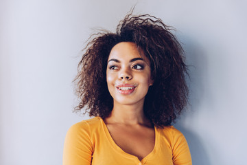 Wall Mural - Exited smiley face  African American girl portrait at home.Happiness concept