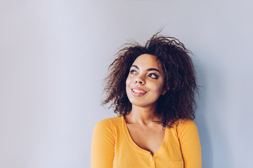 Wall Mural - Exited smiley face  African American girl portrait at home.Happiness concept