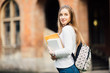 © F8  \ Suport Ukraine - Student girl outdoors with bag and books near University