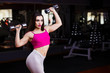 © Vadym - Young attractive muscular smiling fitness woman doing exercise with dumbbells in gym