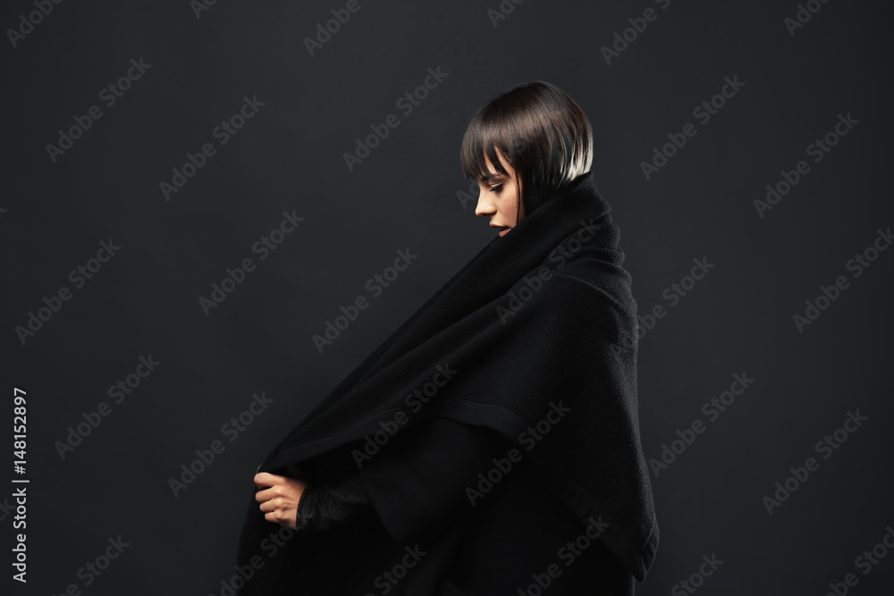 Beautiful young woman on dark background