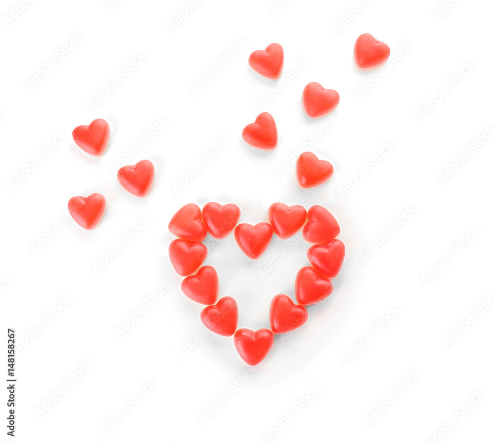 Composition of heart-shaped jelly candies on white background