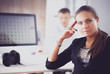 © shefkate - Young woman working in office, sitting at desk