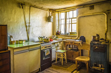 Dirty Dark Kitchen In An Old Beggar's House. A Grim Abstract Scene About Poverty And Housing Problems.