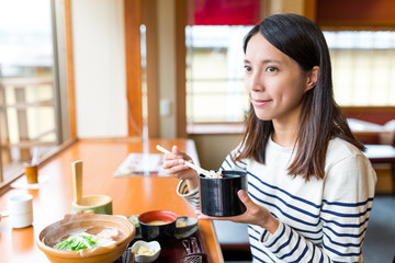 Poster - Woman having lunch in japanese restaurant