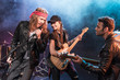 © LIGHTFIELD STUDIOS - Young multiethnic rock and roll band performing music on stage