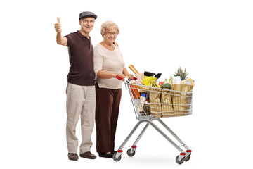 Sticker - Happy seniors with a shopping cart giving thumbs up