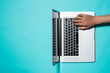 © makistock - Top view of businessman hands busy using laptop at office desk, with copyspace