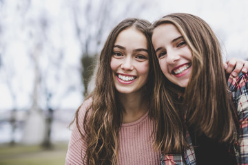 A Portrait of a teen girl with long hair in an urban