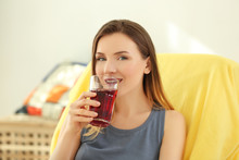 Beautiful Woman Drinking Fresh Juice At Home