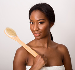 young woman holding a body brush