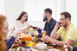 © Prostock-studio - Group of happy young people at dinner table, friends party