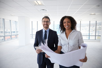 Wall Mural - Portrait Of Businesspeople Looking At Plans In Empty Office