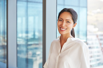 Wall Mural - Portrait Of Businesswoman Standing By Window In Office