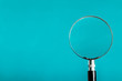 Magnifying glass on blue color background.