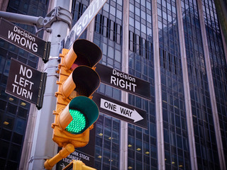 NYC Wall street yellow traffic light black pointer guide one way green light to Right decision way, no turn no way to wrong decision. One way to Right choice. Best choice, right choice. Wall street