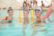 © auremar - Three women in pool holding floats