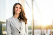 Bright sunny vibrant portrait of beautiful woman business executive style in downtown urban area