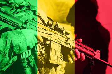 Soldier with machine gun with national flag of Mali