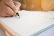 © smolaw11 - Asian Businessman signing name in notebook document, selective focus.
